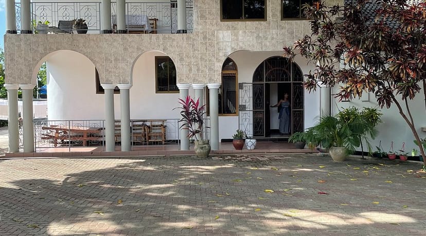 Spacious outdoor lounge with archways, perfect for events and gatherings.