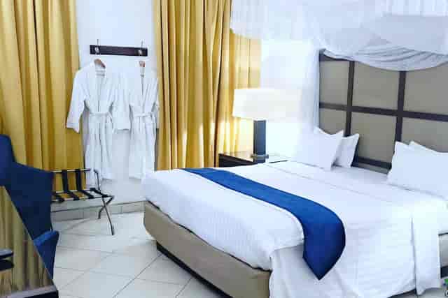 Shamool Hotel room with mosquito net bed, perfect for business travel and retreat accommodations.