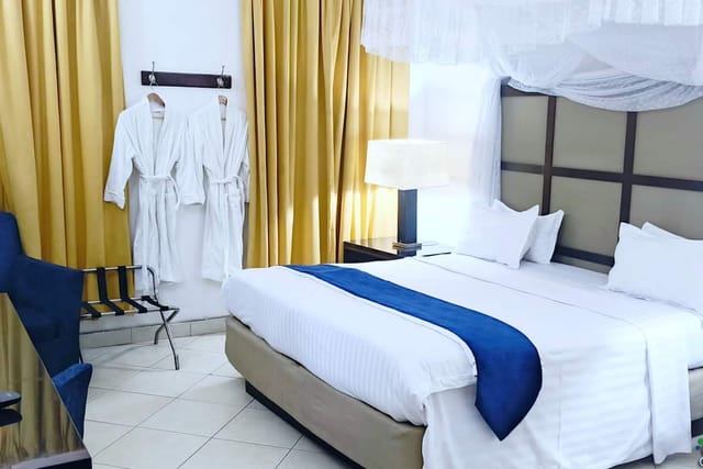 Shamool Hotel room with mosquito net bed, perfect for business travel and retreat accommodations.