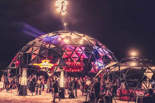 Incendia Fire Pit geodesic dome at North Coast Music Festival, nighttime experiential event.