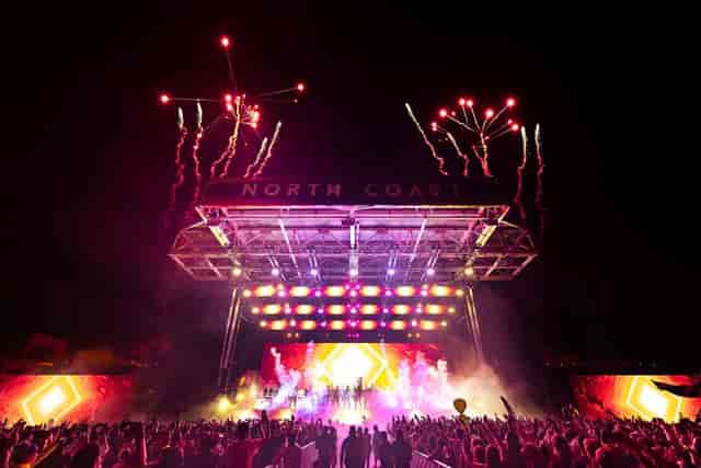 North Coast Music Festival stadium stage with pyrotechnics and LED visuals for event production.