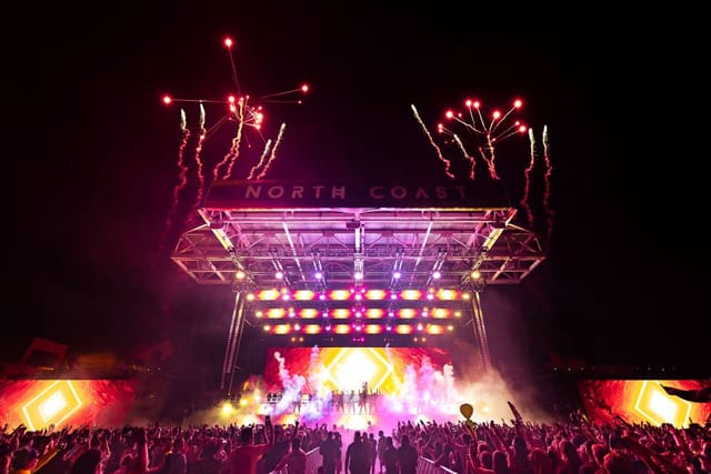 North Coast Music Festival stadium stage with pyrotechnics and LED visuals for event production.