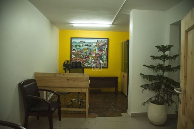 Private office at WORQ co-working space with cramped, unlit breakout area for business meetings.