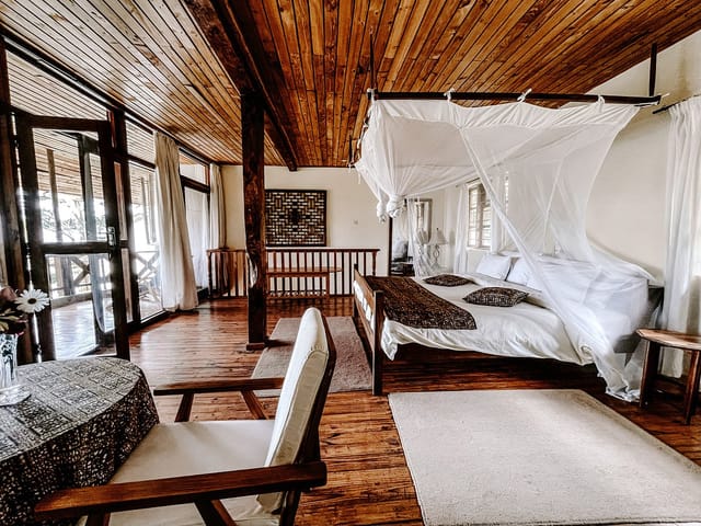 Rustic safari-style guest suite at Utengule Coffee Lodge for corporate retreats and wellness travel.