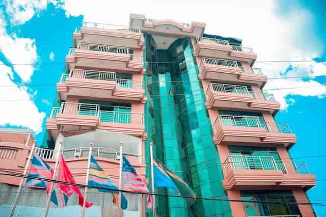 Modern Rungwe City Hotel with glass facade for corporate events and business conferences.