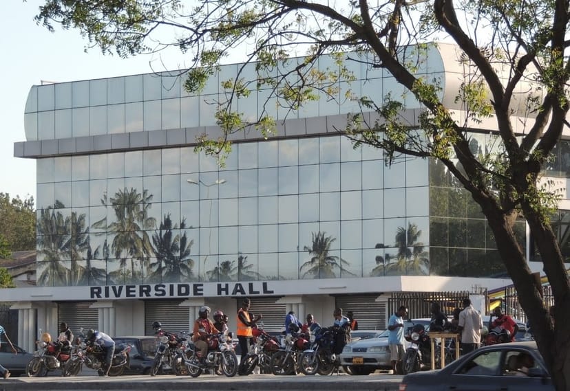 Riverside Hall Main Hall entrance with motorcycle parking; event venue and logistics area.