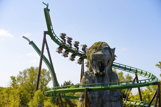 "Thrilling roller coaster near lion sculpture at Chessington for corporate events."