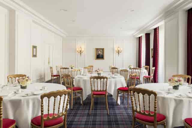 Elegant meeting space with round tables for upscale corporate events at InterContinental Paris.