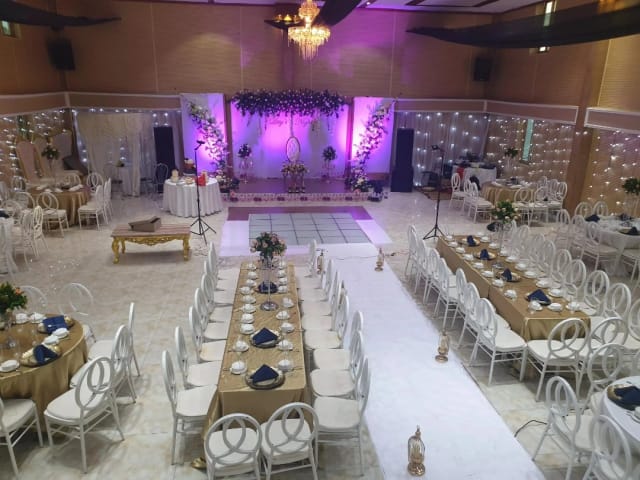 Banquet hall at Cutchi Hall Mnazi Mmoja with wedding setup, stage lighting, and elegant decor.