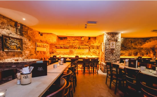 Rustic subterranean Brunnenzimmer venue, ideal for team dinners and networking receptions.