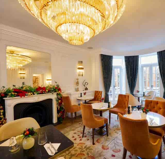 Chesham Hotel Belgravia lounge with plush orange chairs, ideal for upscale gatherings and meetings.