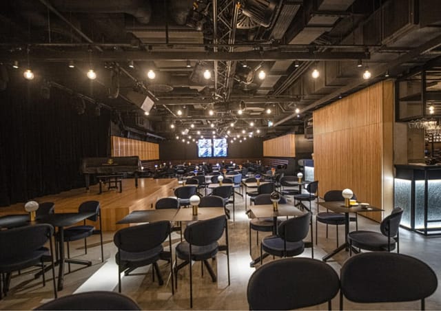 Jasmine reception venue: cabaret-style seating with stage for corporate events and workshops.