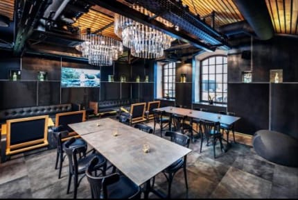 VIP lounge at Polish Vodka Museum with industrial-chic chandeliers for corporate events or galas.