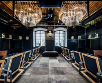 VIP lounge at Koneser Cocktail Bar, industrial boardroom for exclusive corporate events.
