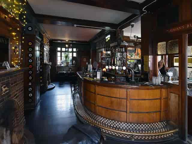 Wood-paneled Stag's Head Hoxton pub interior for networking events and team-building.