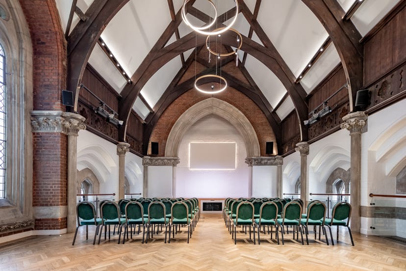 Upper Hall theater-style venue with vaulted timber ceilings for conferences and presentations.