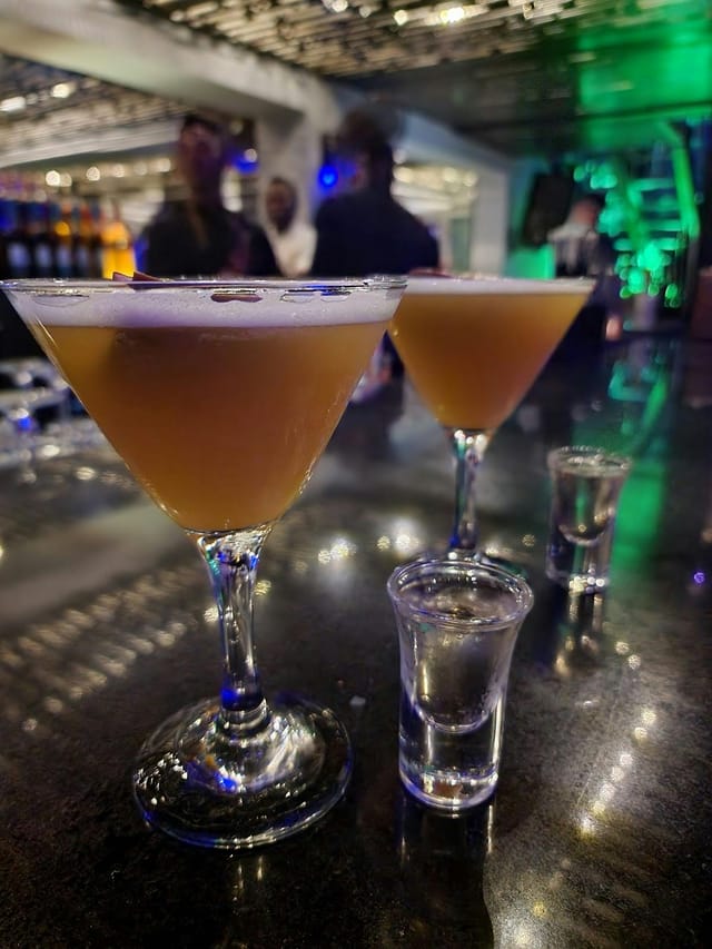 Craft cocktails at Vertigo Hotel rooftop networking event for post-conference reception.