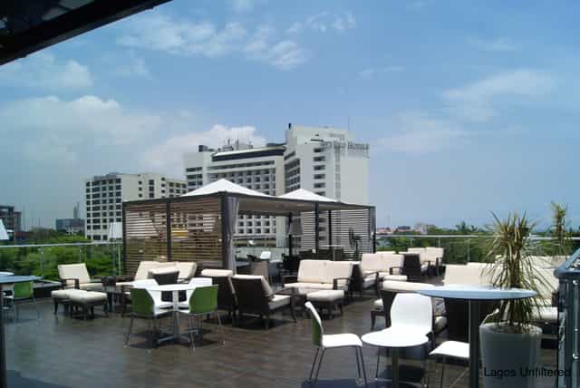 Rooftop bar lounge with stylish seating for corporate cocktail receptions and networking events.