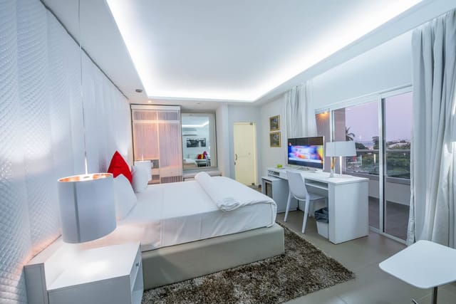 Modern hotel guest room with workspace for business travel and remote work.