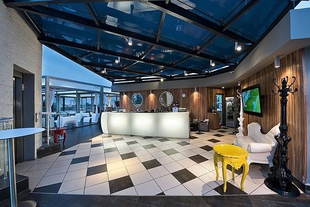 Four Degrees Bar: Premium glass atrium lounge for corporate events and networking receptions.