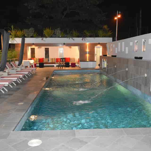 Poolside networking venue at Maison Fahrenheit with upscale water features for evening receptions.