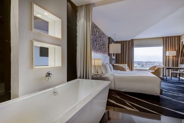 Luxury hotel suite in Radisson Lagos Ikeja with executive desk for VIP business travel and events.