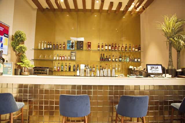 Luxury gold bar at Jinja, EbonyLife Place, ideal for intimate VIP networking and event receptions.