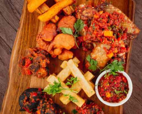 Rustic catering platter with fried proteins for high-end networking events and cocktail hours.