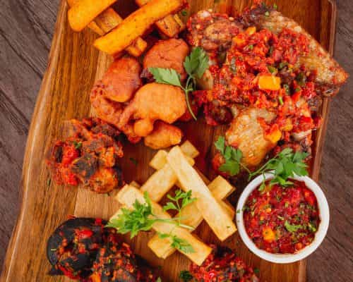 Rustic catering platter with fried proteins for high-end networking events and cocktail hours.