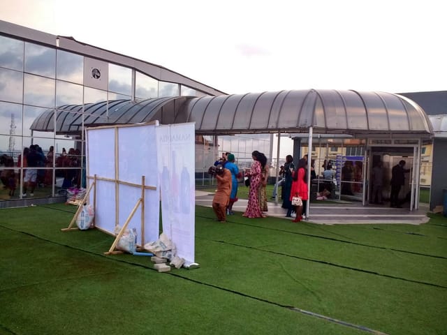 Lekki Coliseum rooftop conference hall with branded step-and-repeat for corporate event planning.