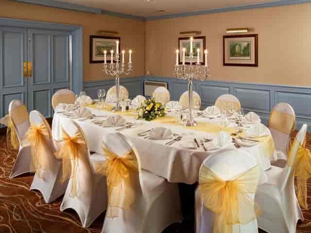 Mercure Livingston banquet room with gold accents for corporate dinner and wedding events.