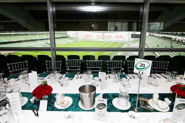 VIP corporate hospitality suite with pitch-side views for exclusive networking and client events.