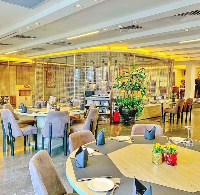 Modern private lounge at Noir Lagos with round tables for corporate networking and events.