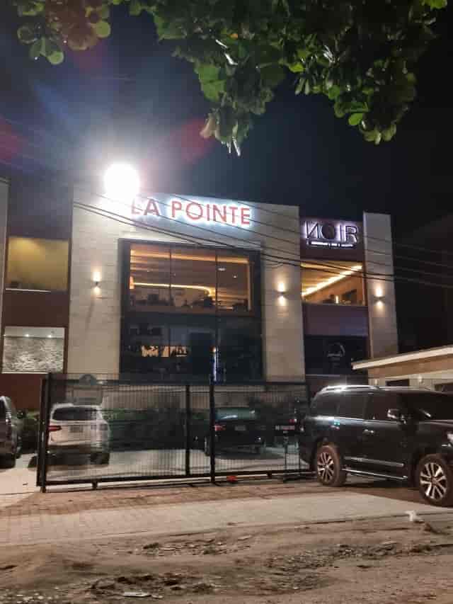 Modern Noir Lagos restaurant exterior featuring illuminated facade for corporate networking events.
