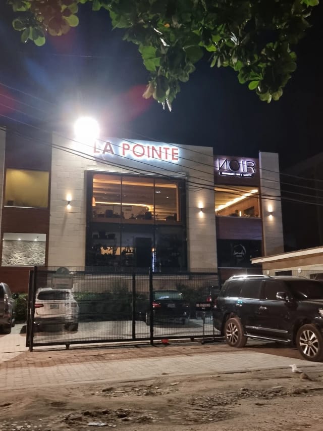 Modern Noir Lagos restaurant exterior featuring illuminated facade for corporate networking events.