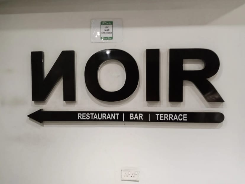 Directional signage in Noir Lagos bar, effective wayfinding for event and hospitality venues.