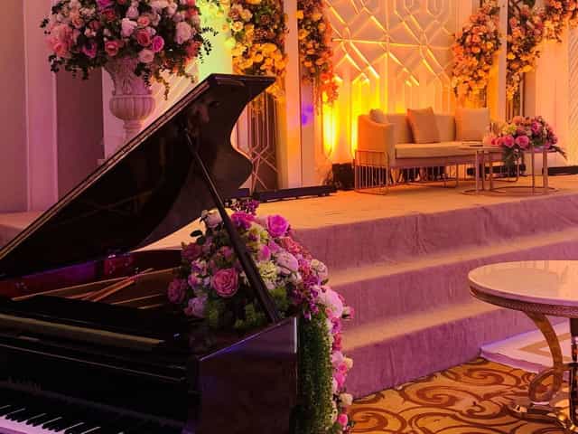 Imperial Banquet Hall stage with grand piano for elegant weddings and luxury corporate events.