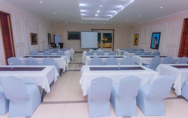 Classroom setup in La Cour Hotel meeting room for corporate training and presentations.
