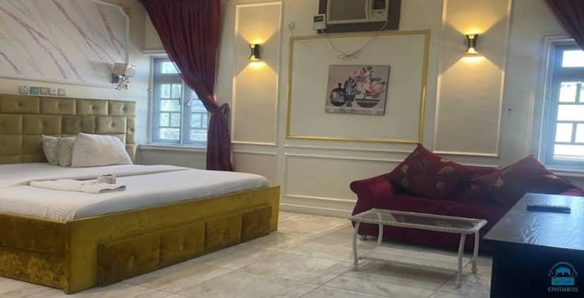 Vatican room at Brighams Suites with dated decor, perfect for event lodging or group booking.