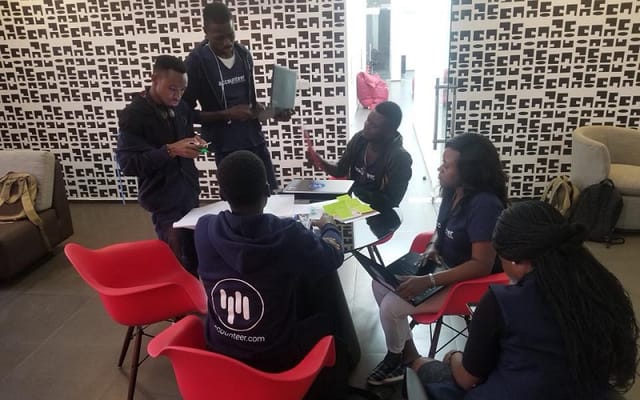 Software training event briefing with team in collaborative lounge space.