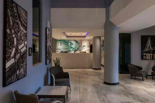 Modern hotel lobby with minimalist check-in, perfect for corporate events and conference networking.