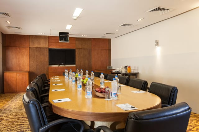 Boardroom-style Eko Expo Hall with AV setup for executive meetings and corporate events.