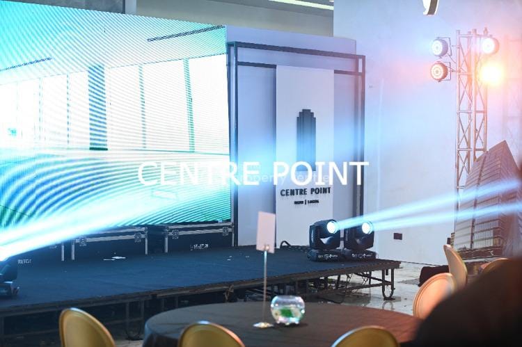 Corporate event hall with large LED wall and professional lighting for business presentations.