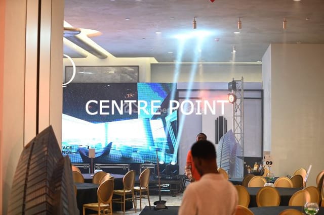 Modern event hall with LED wall and banquet seating for corporate showcases and galas.