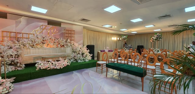Emerald Hall event stage with floral decor, perfect for wedding receptions and luxury celebrations.