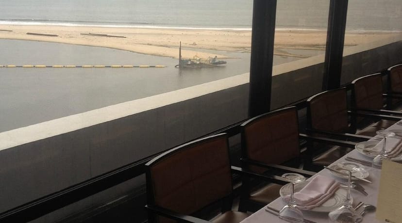 Sky Bar Kilo Royal Hotel: Industrial venue with floor-to-ceiling windows for intimate board dinners.