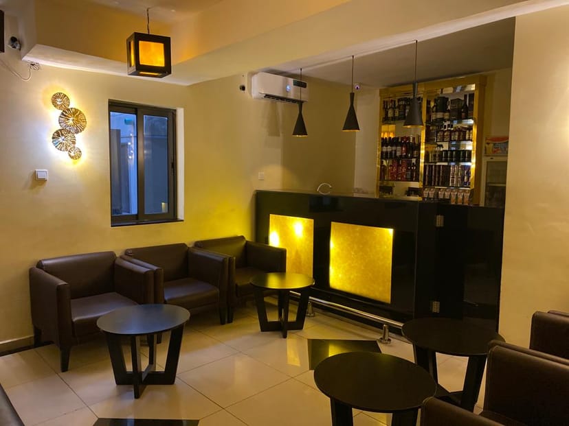 Gold-toned VIP lounge at Adig Suites, perfect for networking events and cocktail parties.