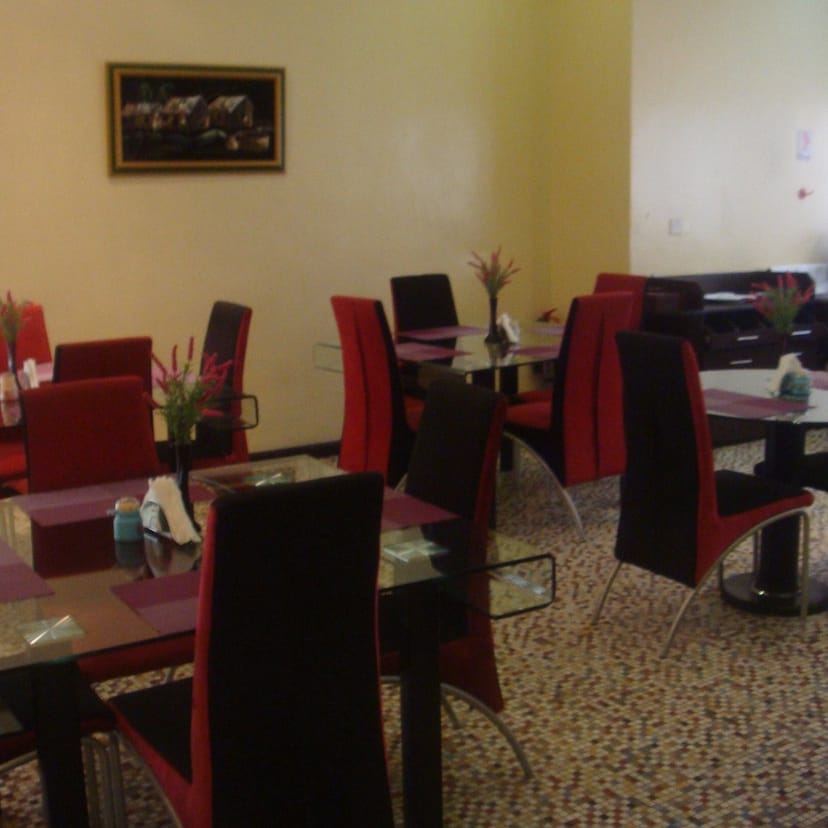 Dated Blue Lodge Hotel dining room with cramped furniture layout for event venue planning.