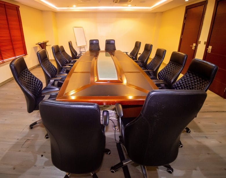 Boardroom at Pearlwort Hotel: Classic table setup for corporate meetings and executive conferences.