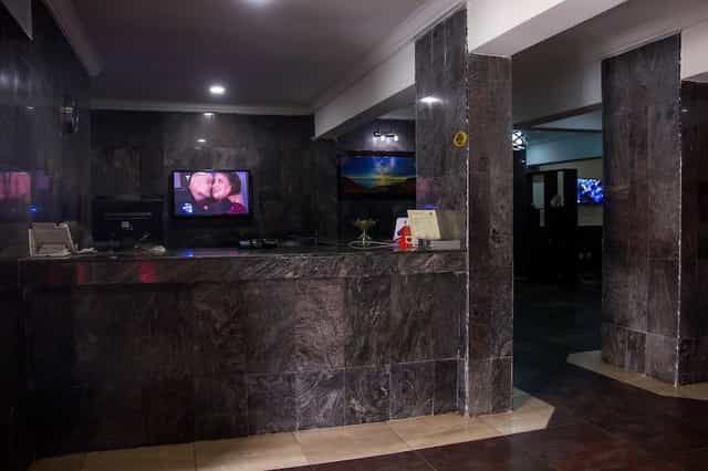 Dimly lit reception desk at Eastgate Hotel Lekki, ideal for event registration and corporate venues.